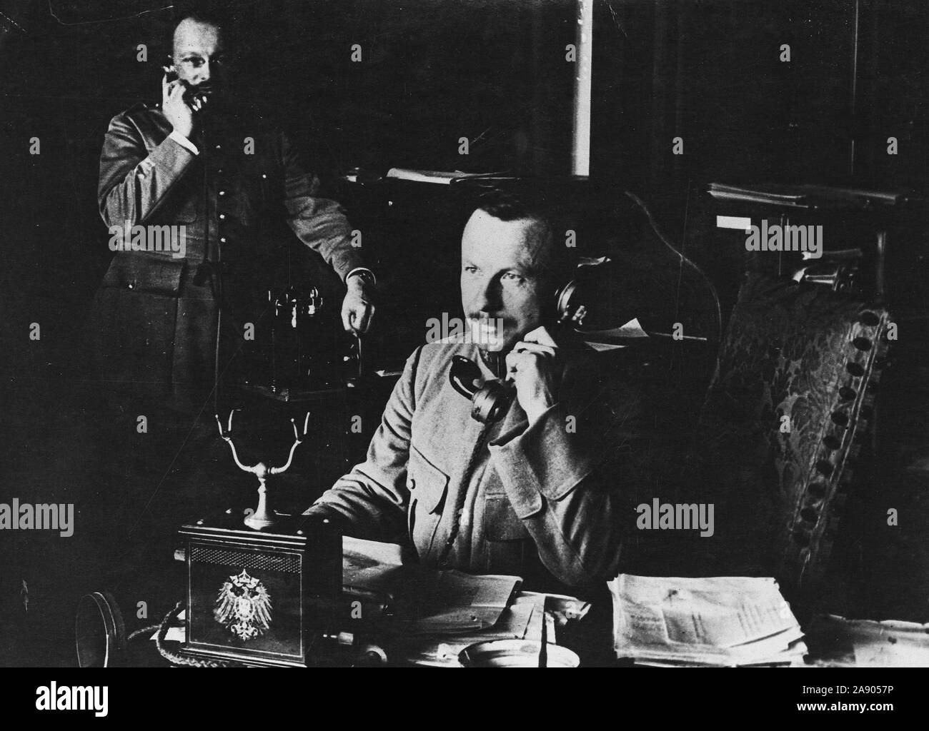 1918 - Armistice - Officers of the Allied Commission at Spa use former Kaiser's phone. French Officer of the Allied Armistice Commission talking through the telephone which the former Kaiser had used Stock Photo
