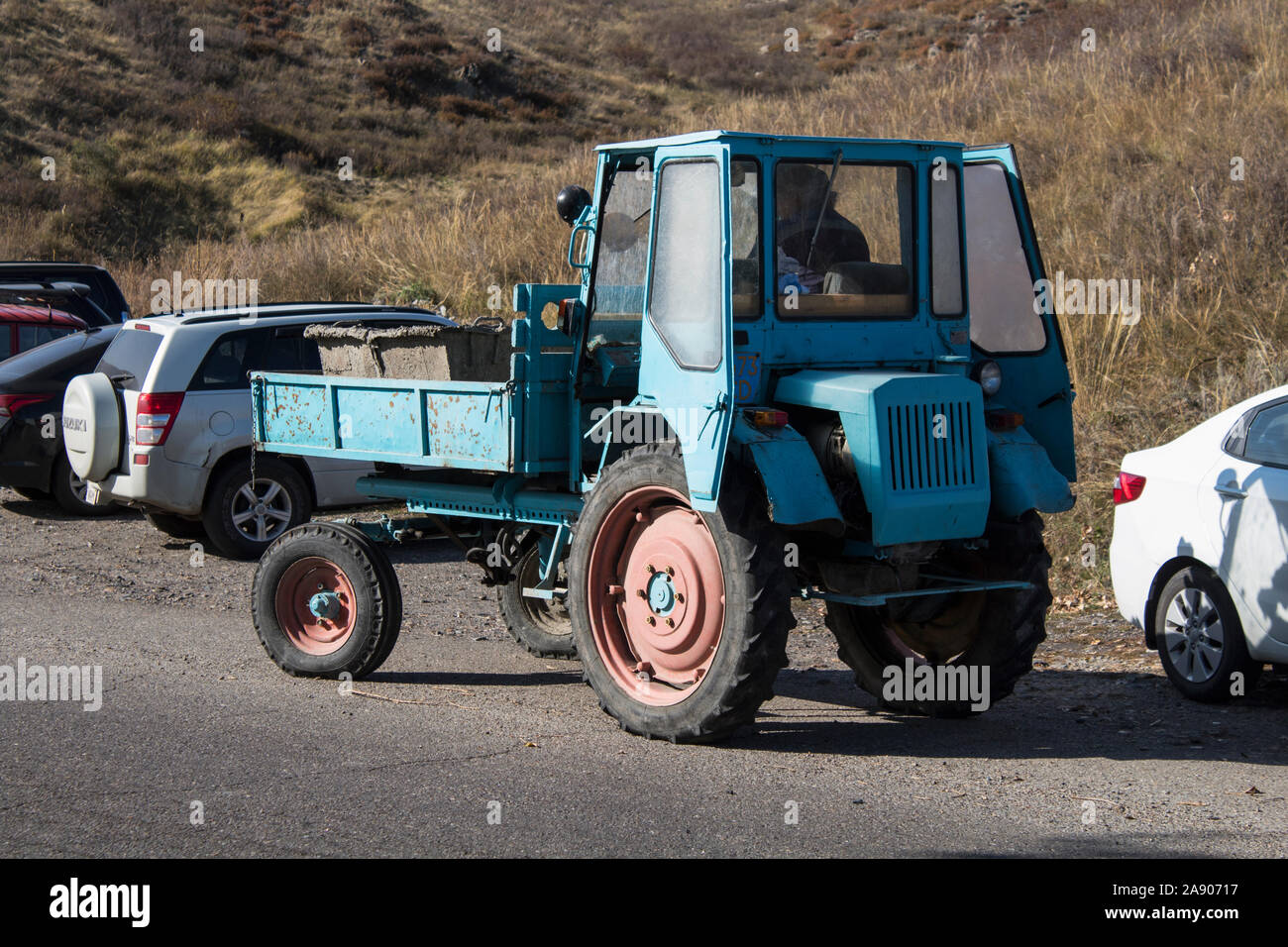 Kazakhstan, Ust-Kamenogorsk - 4 October, 2019. Old tractor on the road. Stock Photo