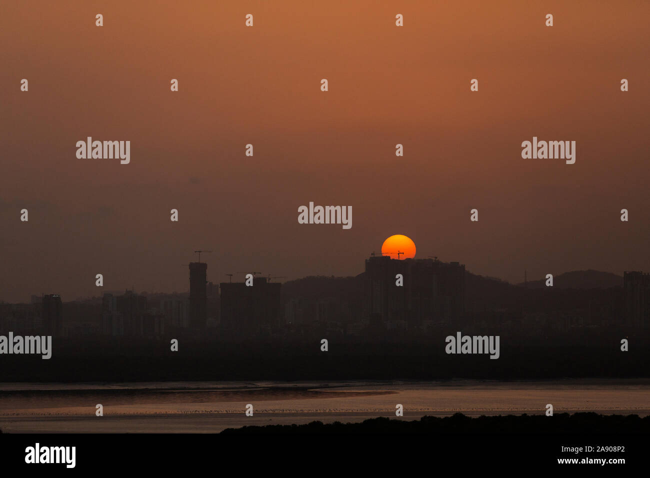 Sunset Over Powai Skyline seen from Navi Mumbai,Maharashtra,India Stock Photo