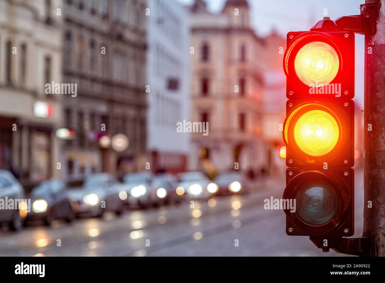 A city crossing with a semaphore. Red and orange light in semaphore ...