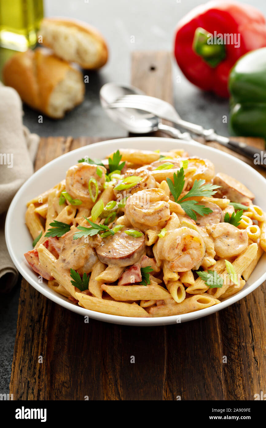 Cajun shrimp and sausage penne pasta in a bowl Stock Photo