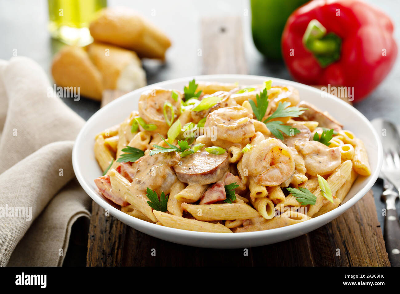 Cajun shrimp and sausage penne pasta in a bowl Stock Photo