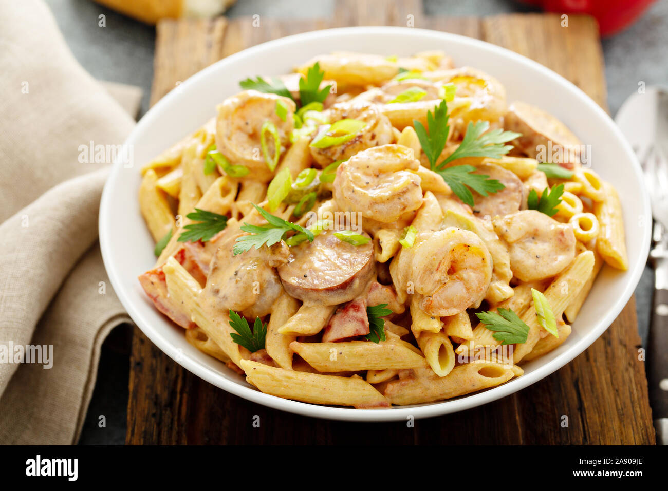 Cajun shrimp and sausage penne pasta in a bowl Stock Photo