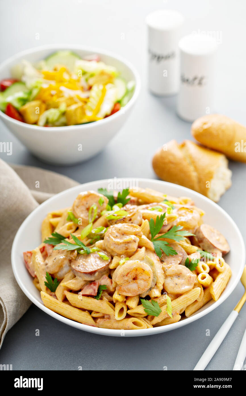 Cajun shrimp and sausage penne pasta in a bowl Stock Photo