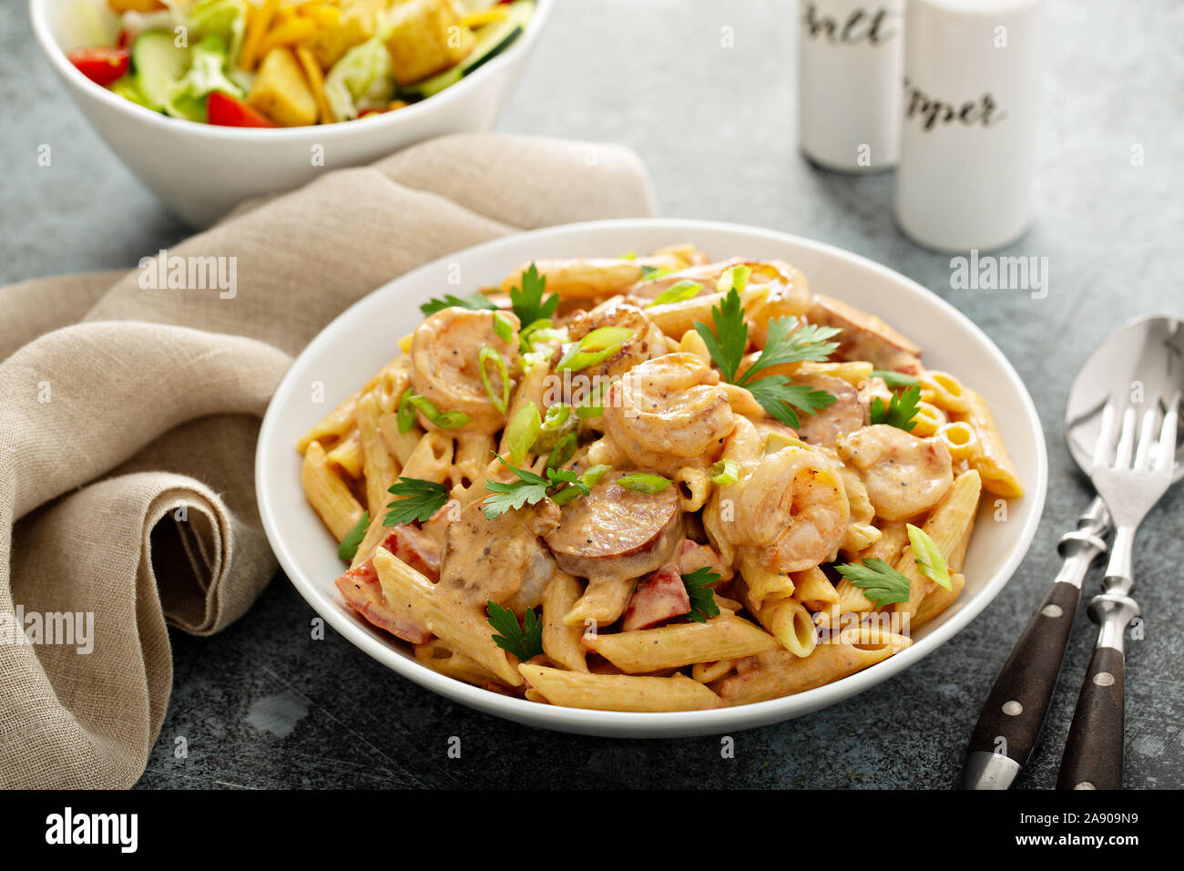 Cajun shrimp and sausage penne pasta in a bowl Stock Photo