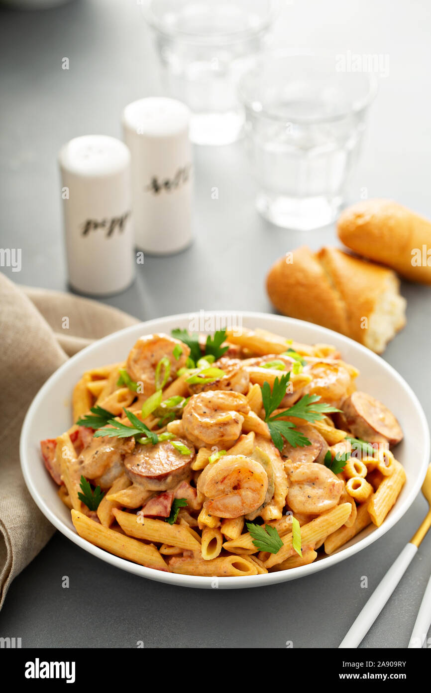Cajun shrimp and sausage penne pasta in a bowl Stock Photo