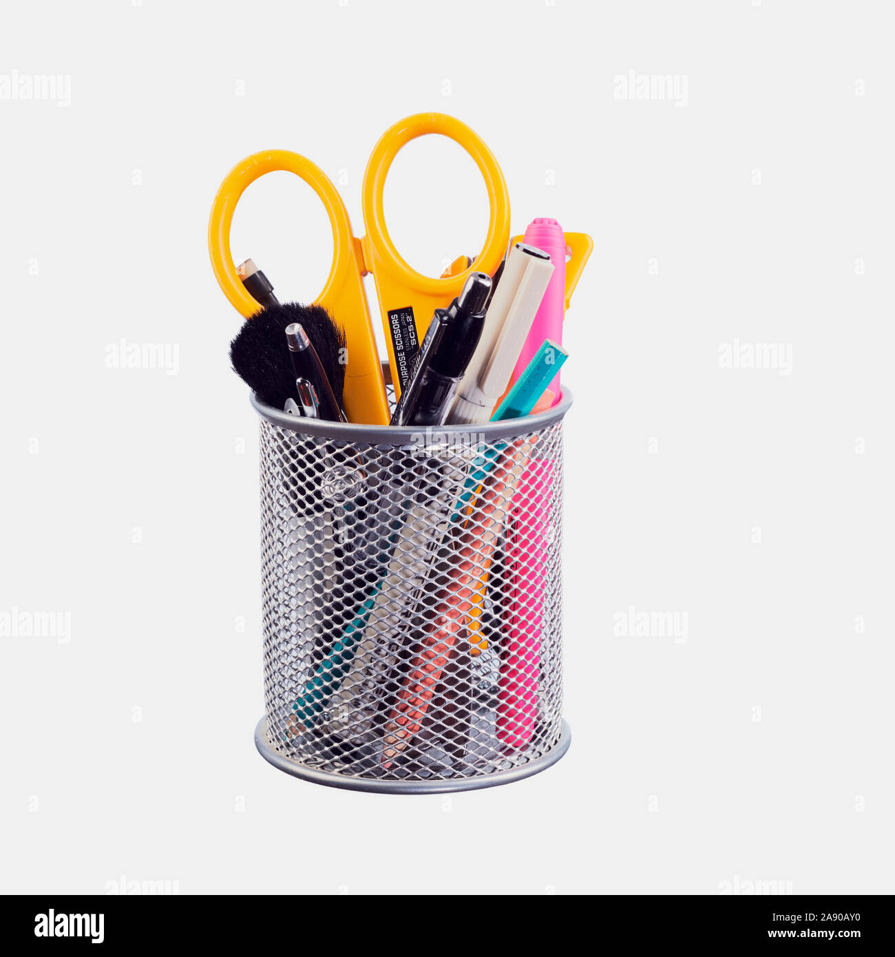 A silver mesh pencil and pen holder for organizing desk items for neatness and easy use. Stock Photo