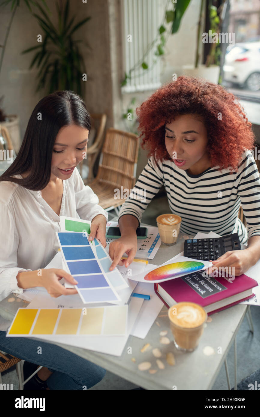 Interior designer discussing project hi-res stock photography and ...