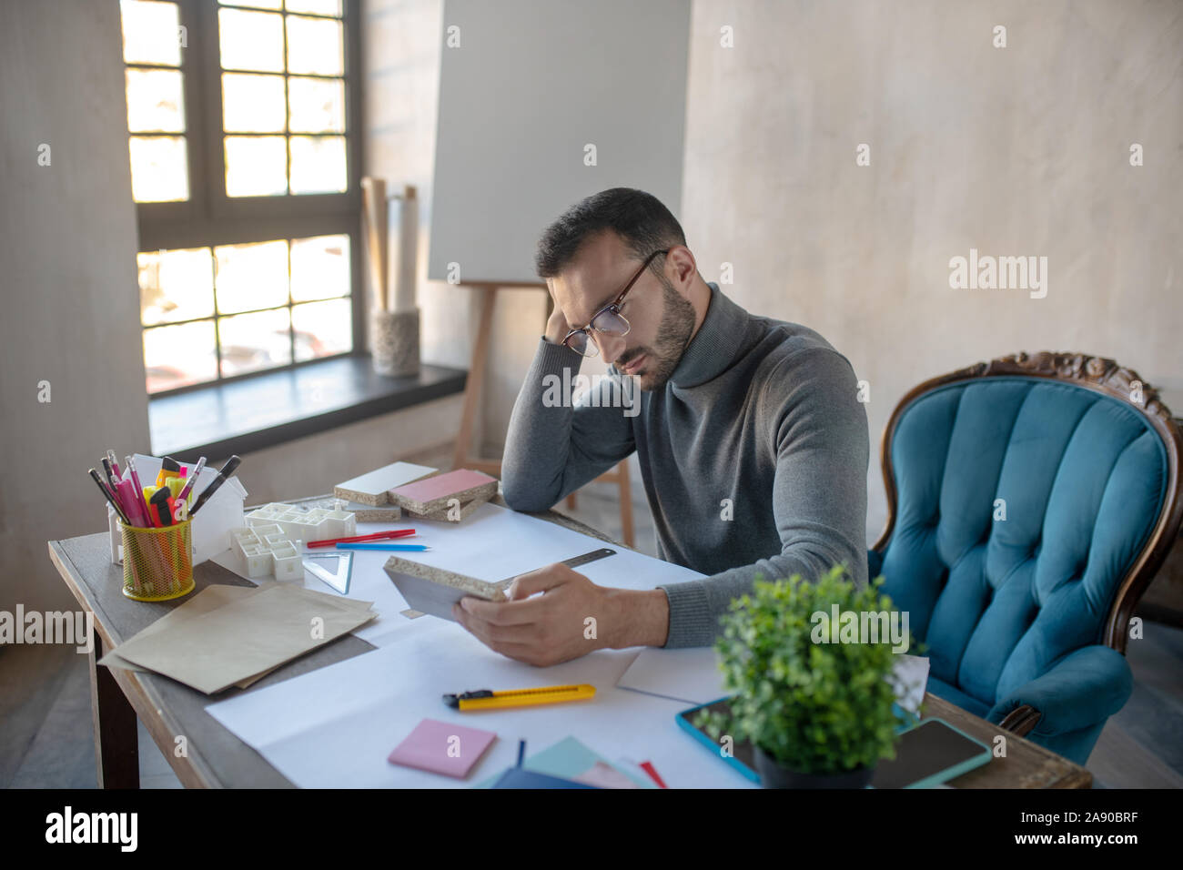 Interior designer feeling thoughtful while creating project Stock Photo ...