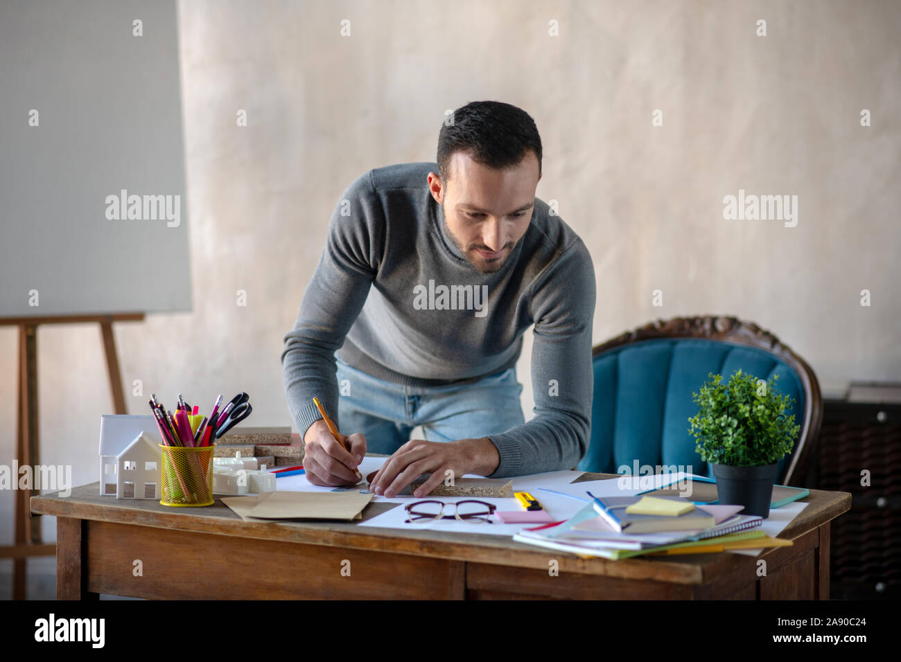 Handsome interior designer making sketches for new project Stock Photo