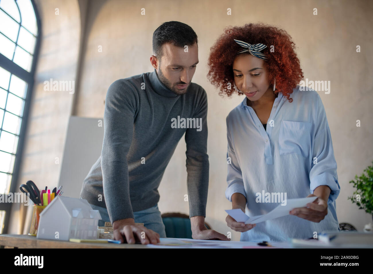 Two interior designers discussing new project Stock Photo - Alamy