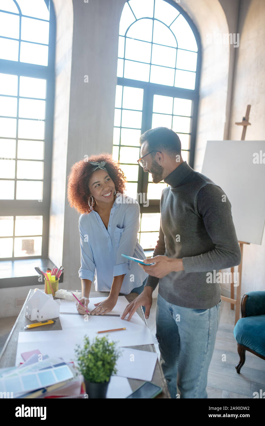 Couple enjoying work together while making sketches Stock Photo