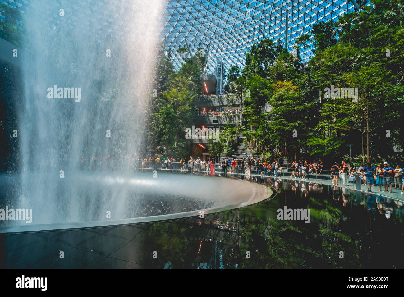 Massive flow of waters from the Rain Vortex cascades into this huge round basin that holds up to over 30,000 litres of water at Jewel Changi Airport. Stock Photo
