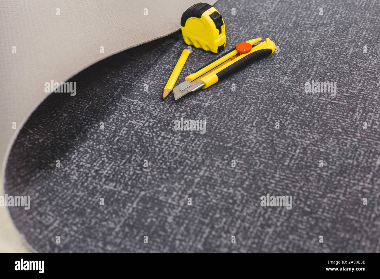 Workplace when laying carpet - finishing work floor covering - copy space Stock Photo