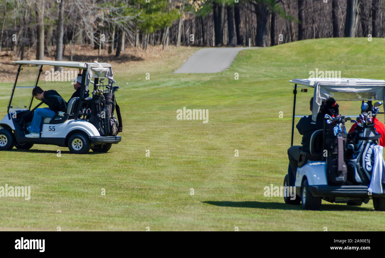 Golfers on golf carts on a golf course. Stock Photo