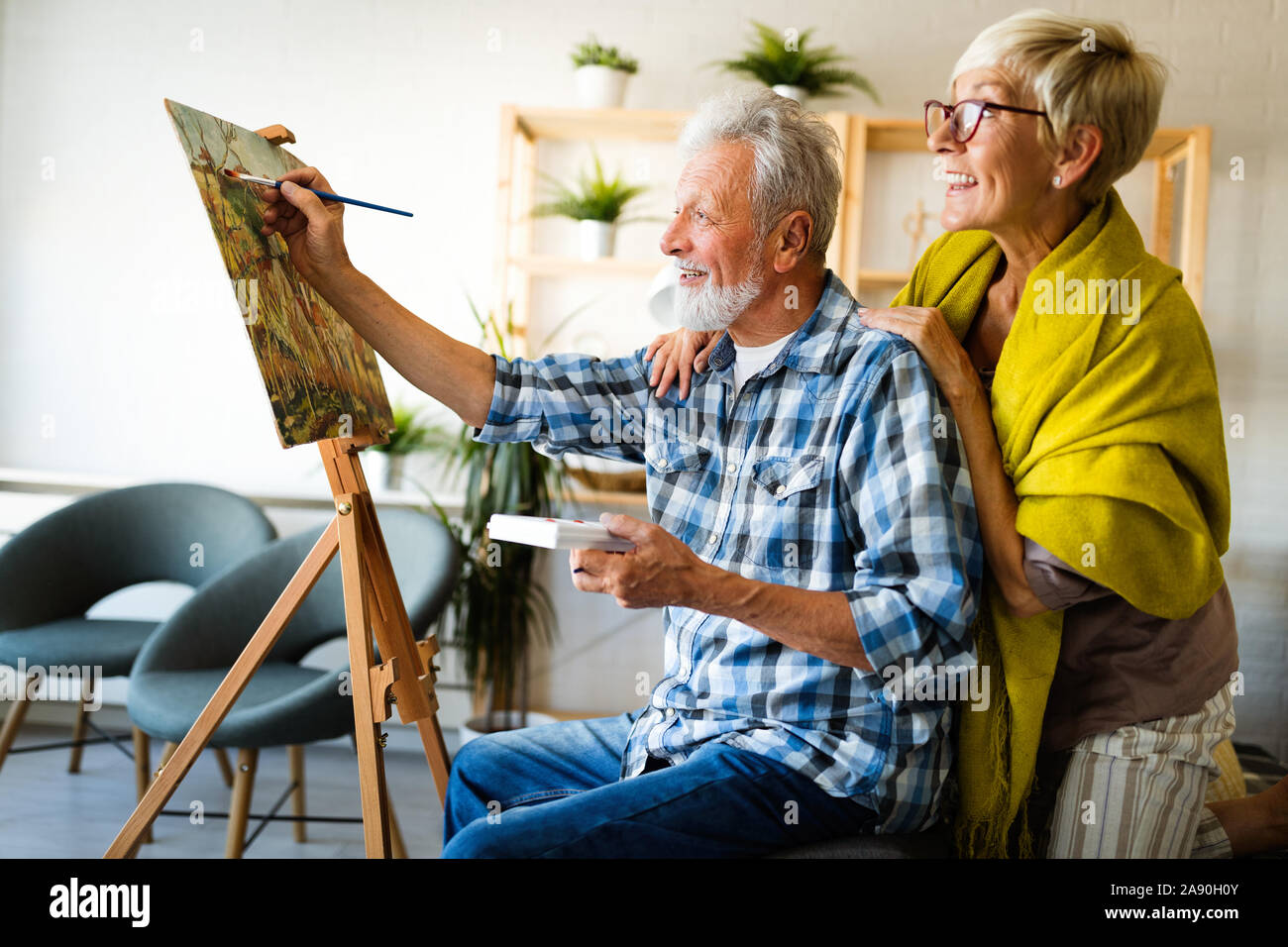 Handsome senior man and attractive old woman are enjoying spending time together Stock Photo