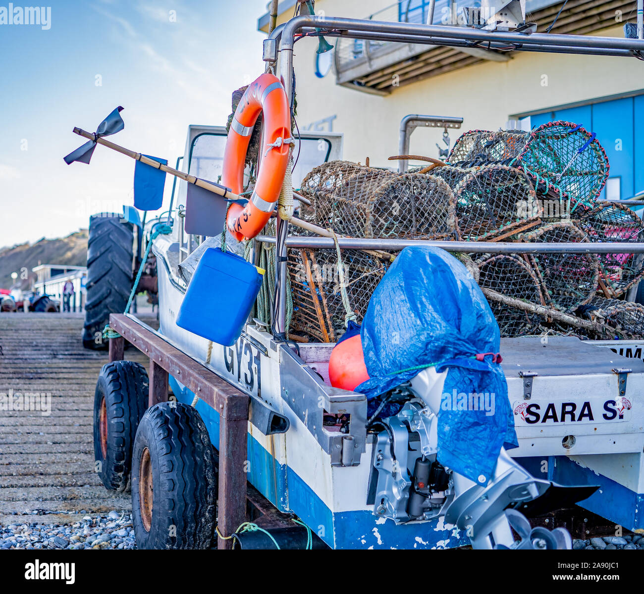 Crab fishing boat moored up on Cromer beach full of empty crab pots