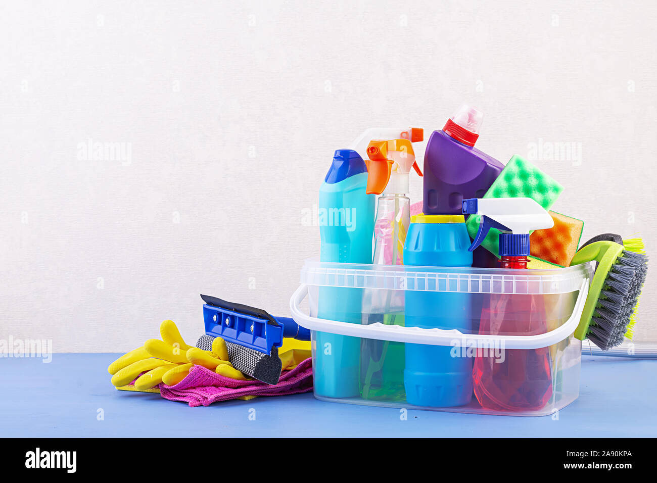 Cleaning service concept. Colorful cleaning set for different surfaces in kitchen, bathroom and other rooms. Stock Photo