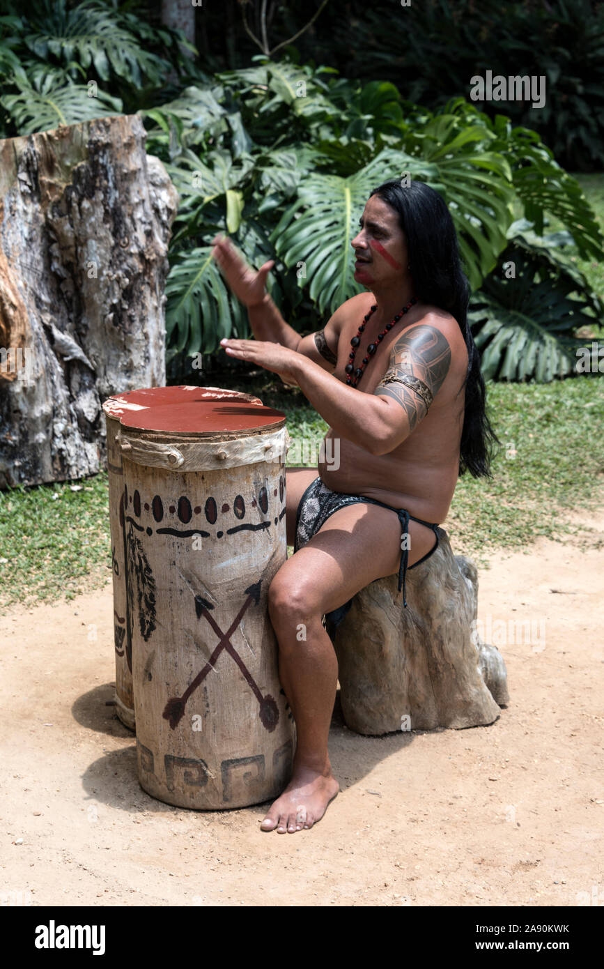 A member of the Taino-Arawak people, performing some traditional music to visiting tourists, visiting the Cueva del Indio, (Indian Cave), a cave, firs Stock Photo