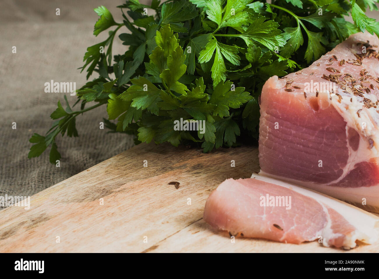 Appetizer in Russian - lard, garlic and parsley on the board Stock Photo