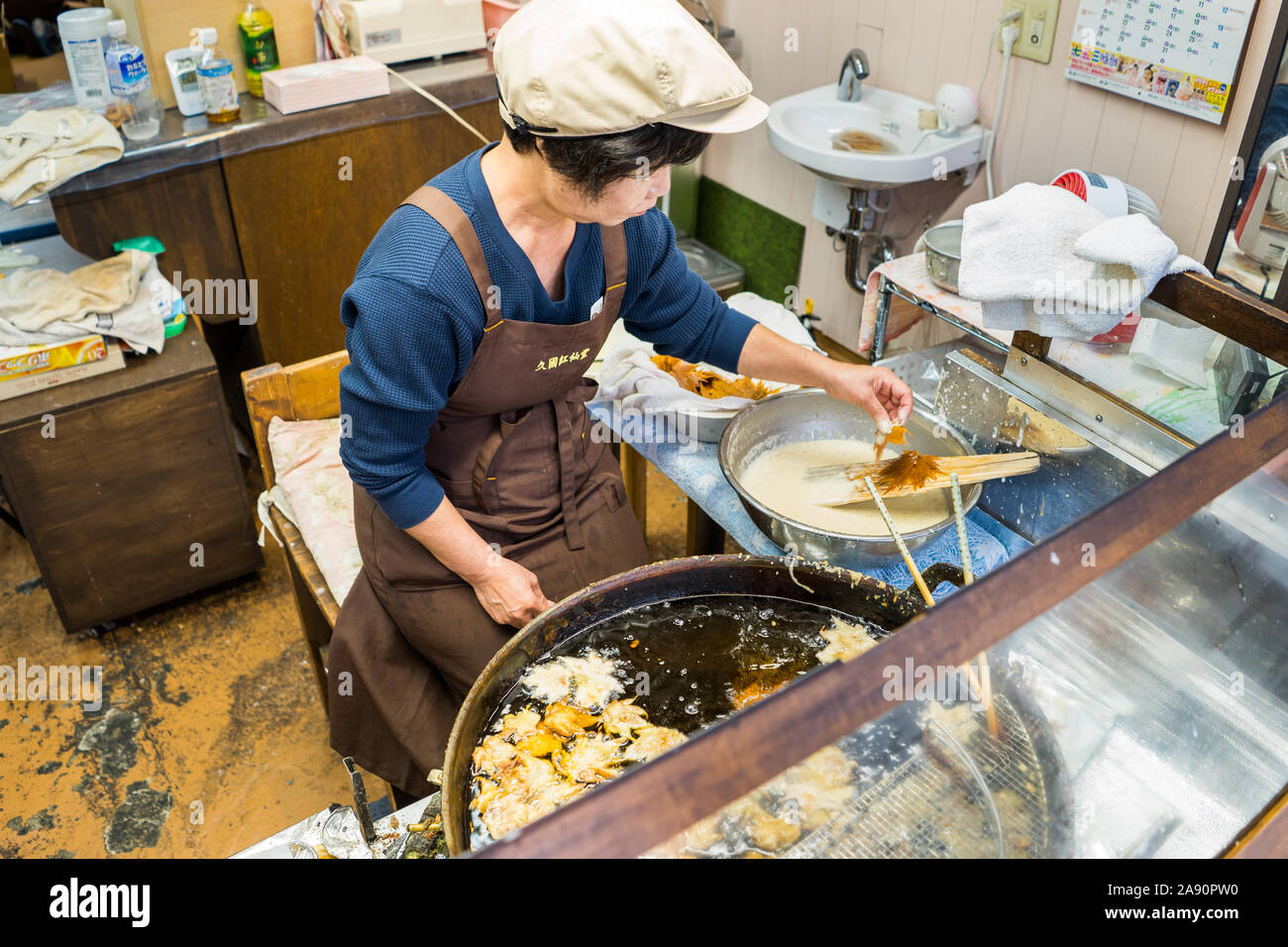 Mature Woman Cooking In Traditional Japanese Kitchen High-Res