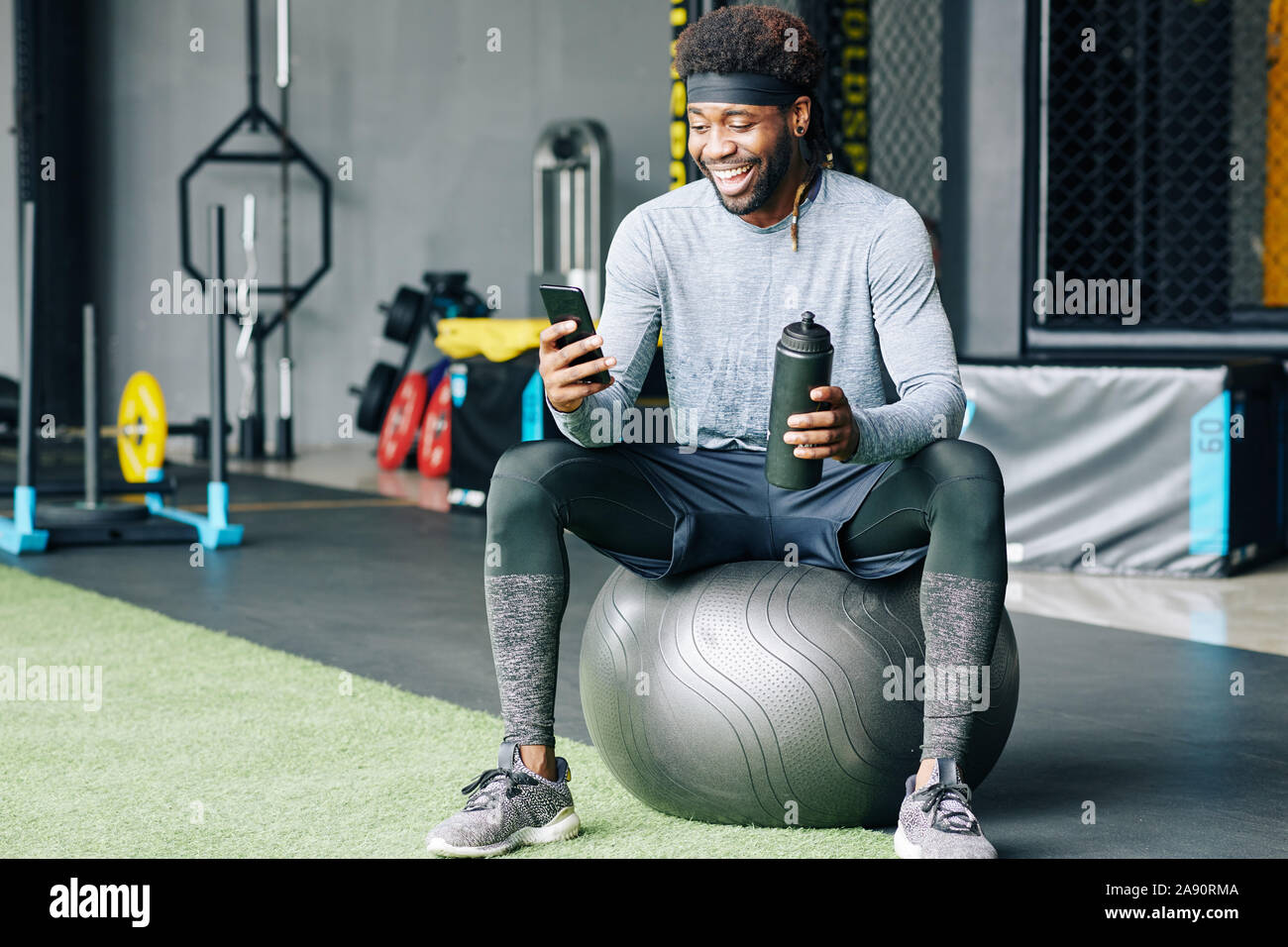 Water bottle, black man in gym and smartphone for social media