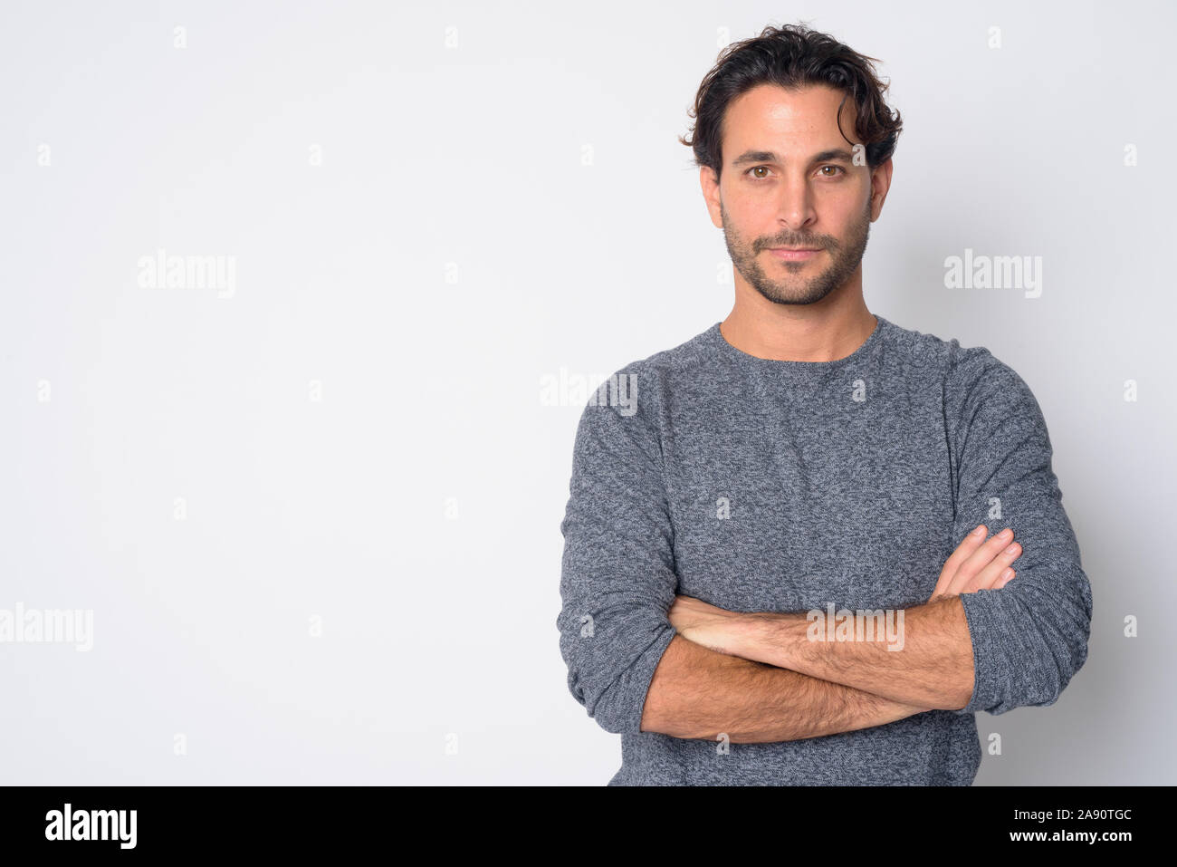Portrait of handsome Hispanic man with arms crossed Stock Photo - Alamy