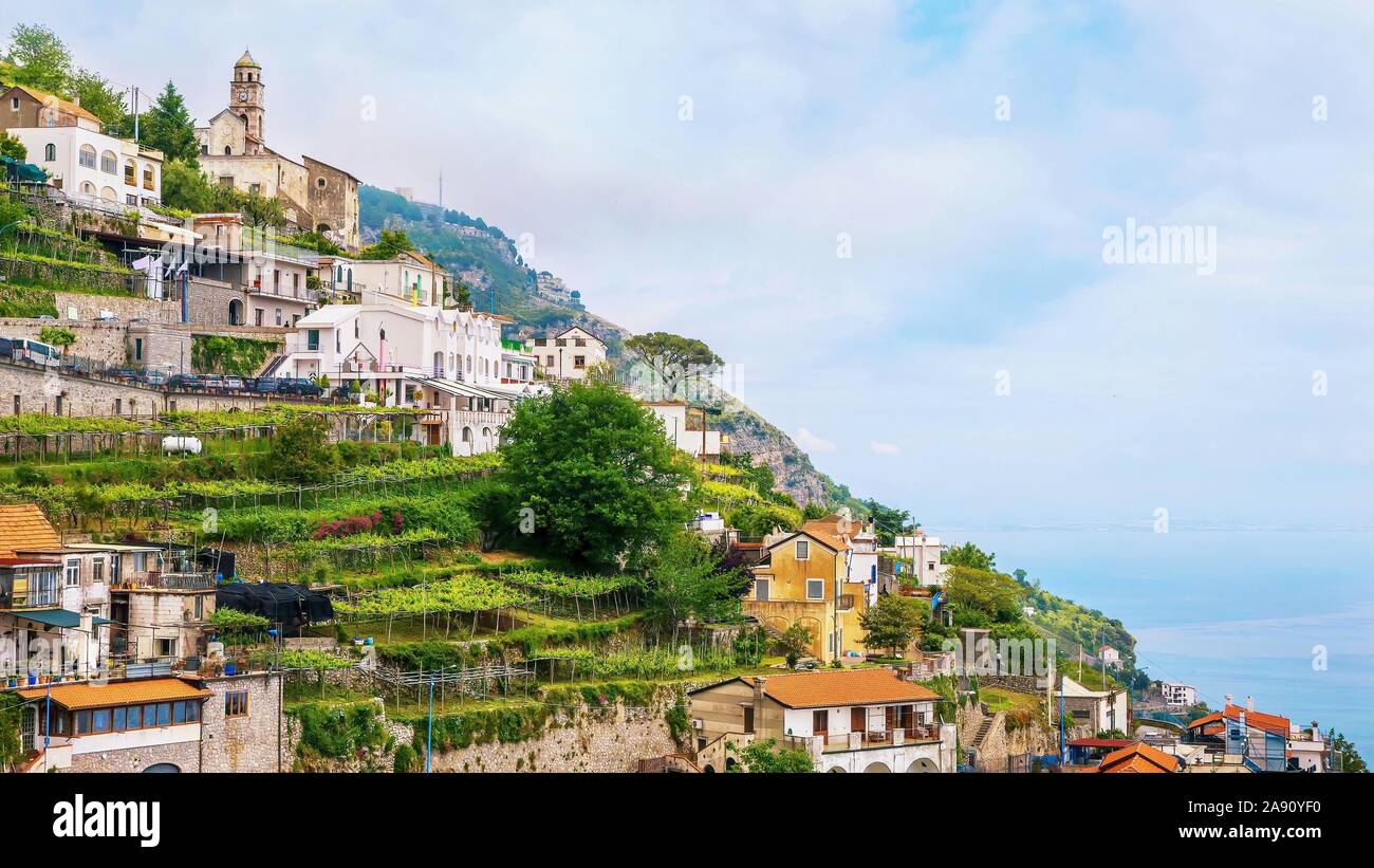 The quaint Italian village of Furore, with picturesque small vineyards and gardens built on a steep terraced hillside overlooking the Mediterranean. Stock Photo
