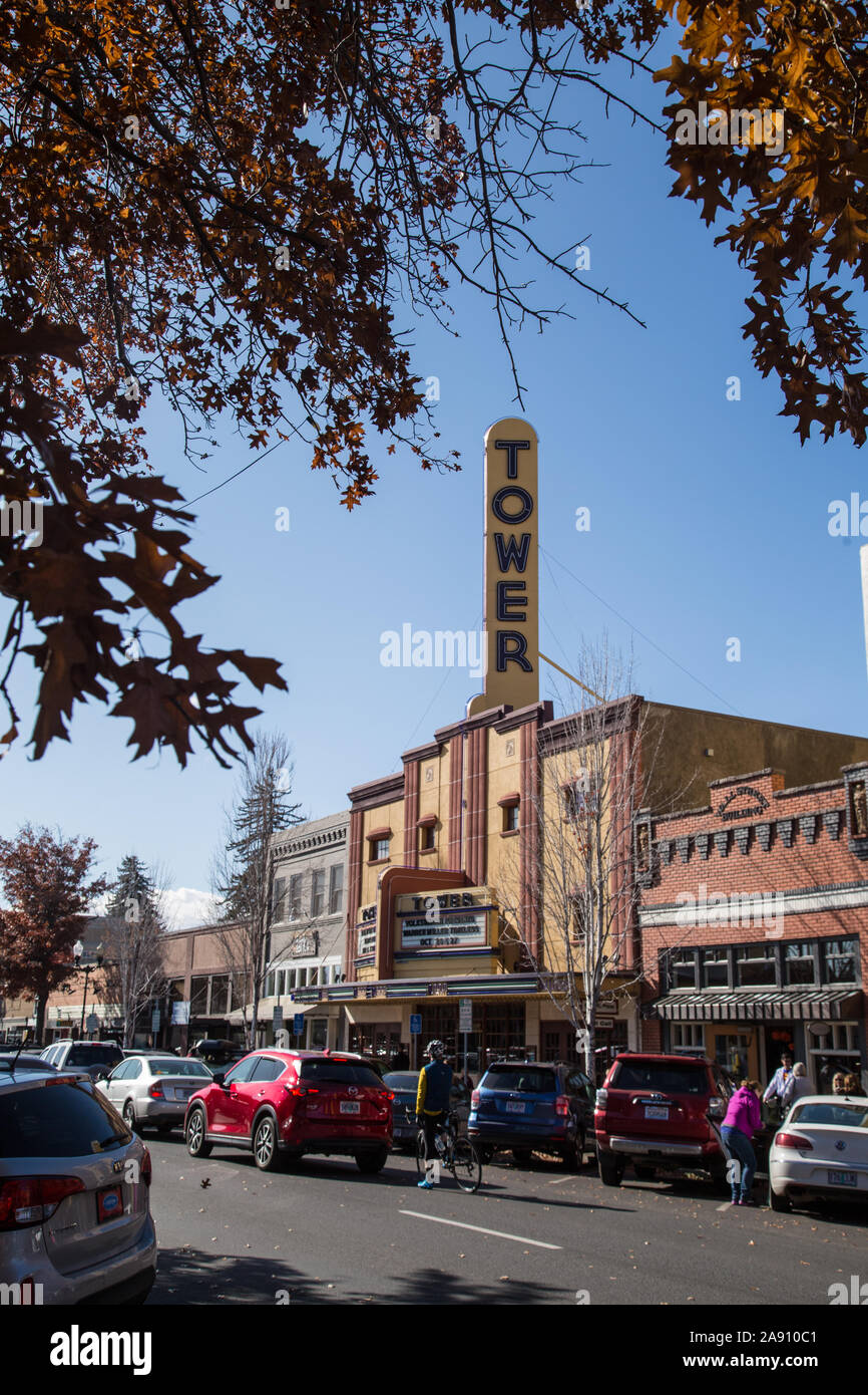 Tree branches hanging over the old Tower Theater on Wall Street in Bend, Oregon, a current music and live theater venue. Stock Photo