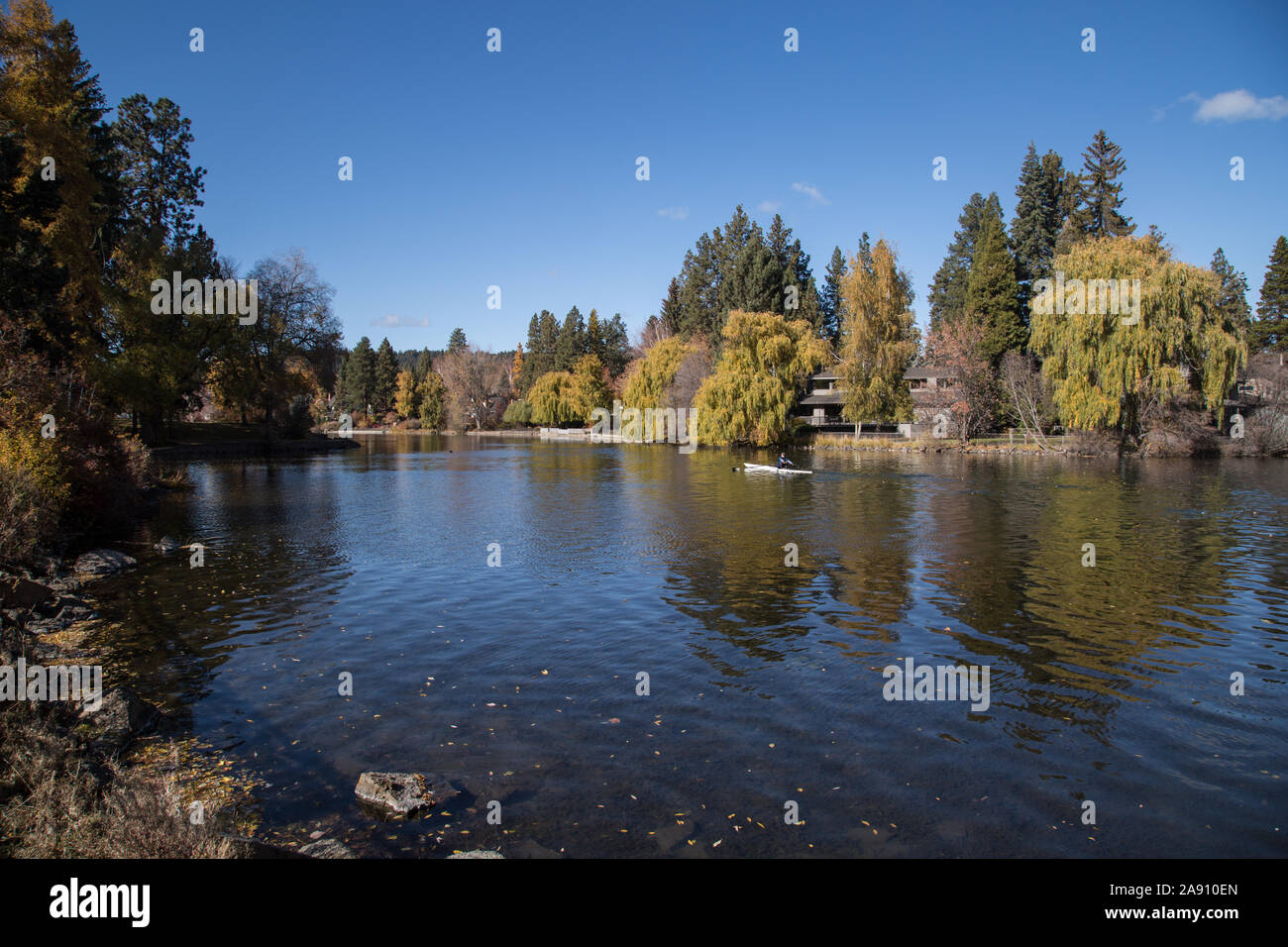 Mirror Pond surrounded by trees with fall foliage next to Drake Park in