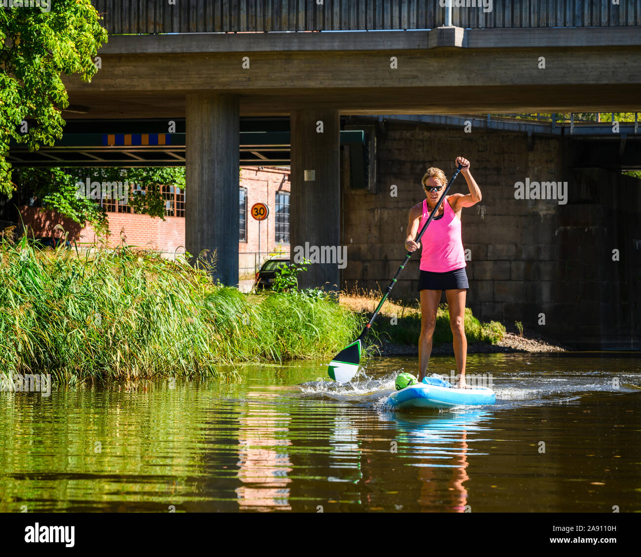 Woman paddle boarding Stock Photo Alamy