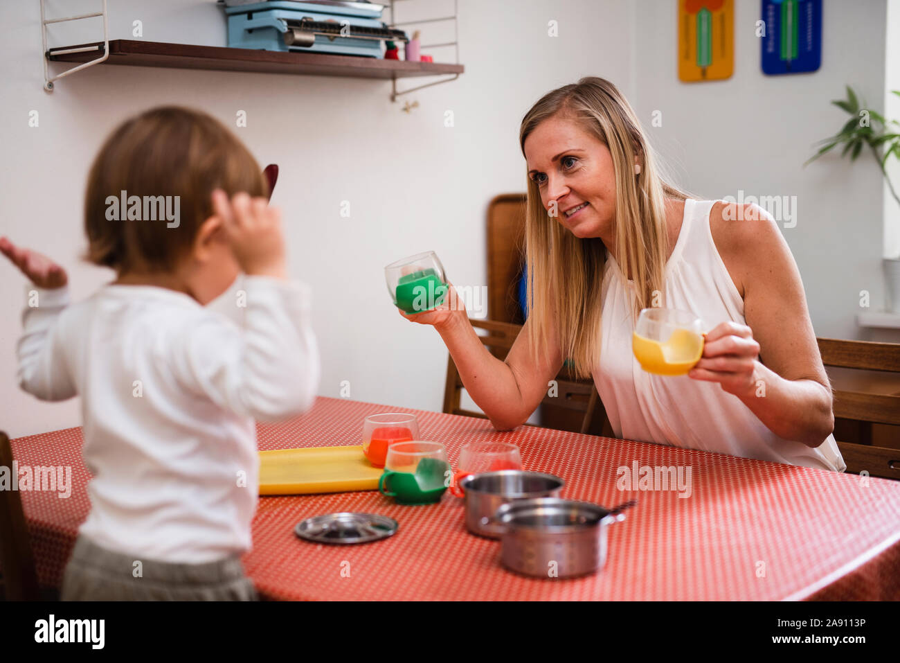 Mother and toddler in kitchen Stock Photo Alamy