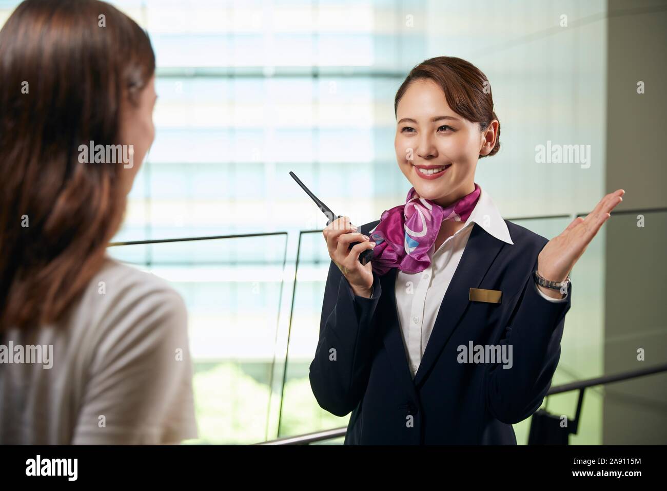 Japanese Flight Attendant helping customer Stock Photo Alamy