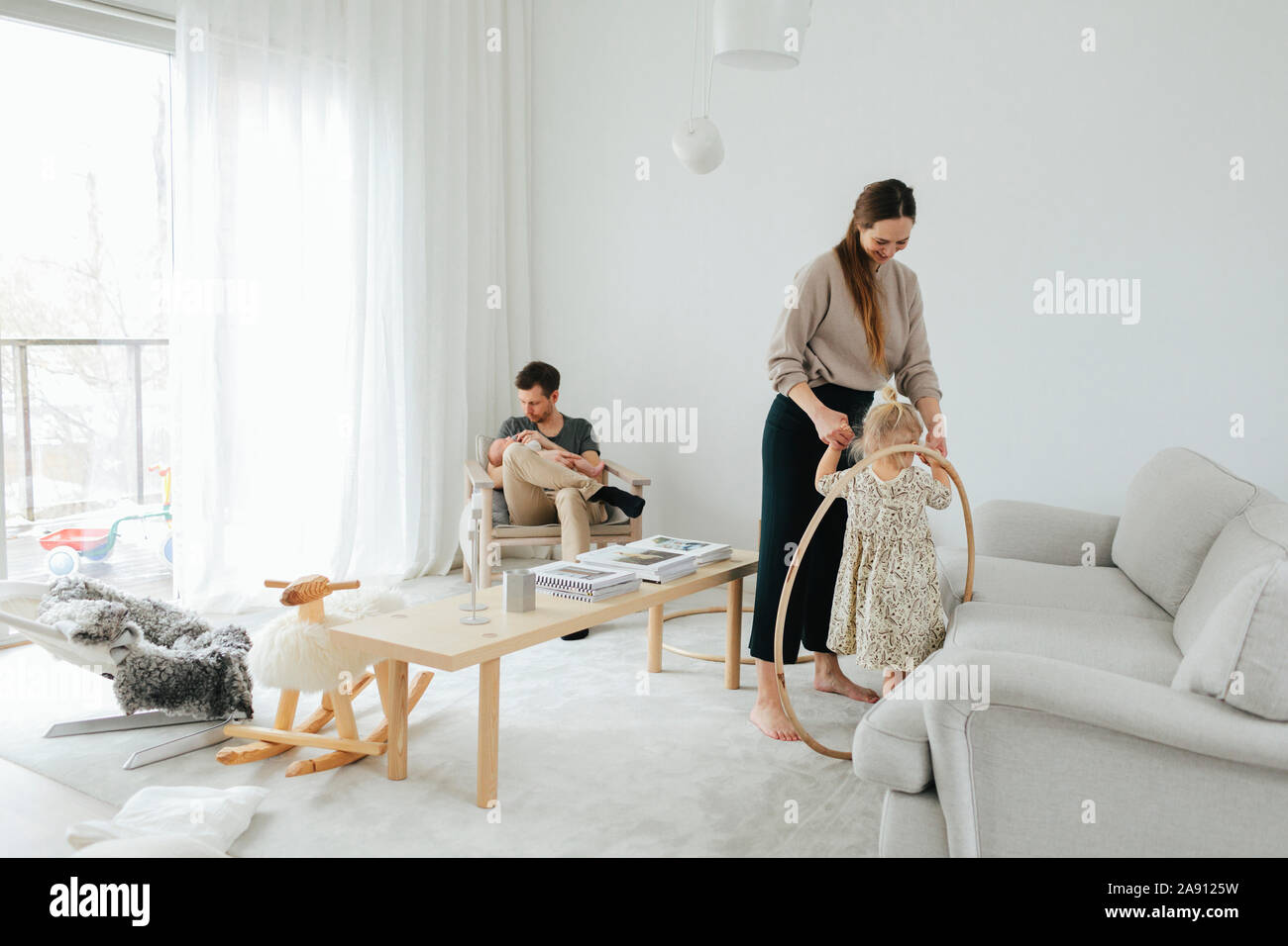 Family in living room Stock Photo - Alamy