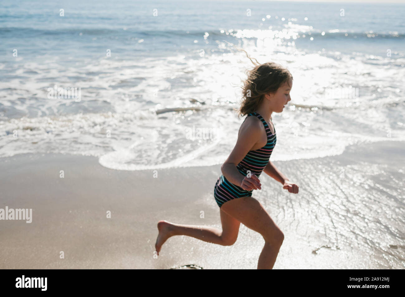Girl running on beach Stock Photo Alamy