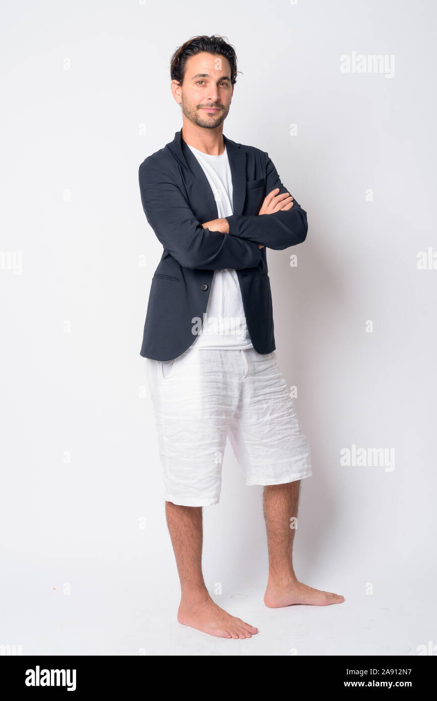 Full body shot of handsome Hispanic businessman with arms crossed Stock ...