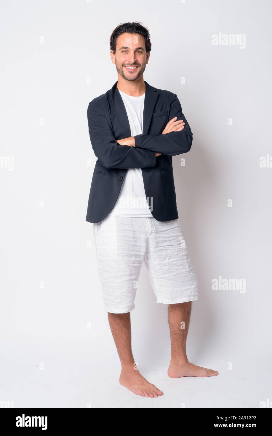 Full body shot of happy Hispanic businessman smiling with arms crossed ...