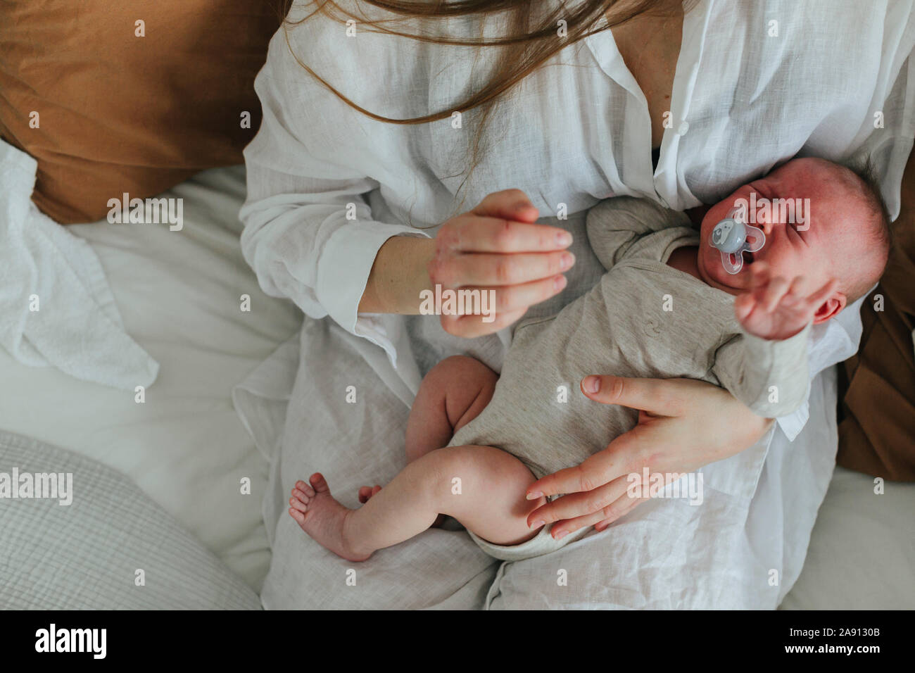 Mother holding crying baby Stock Photo