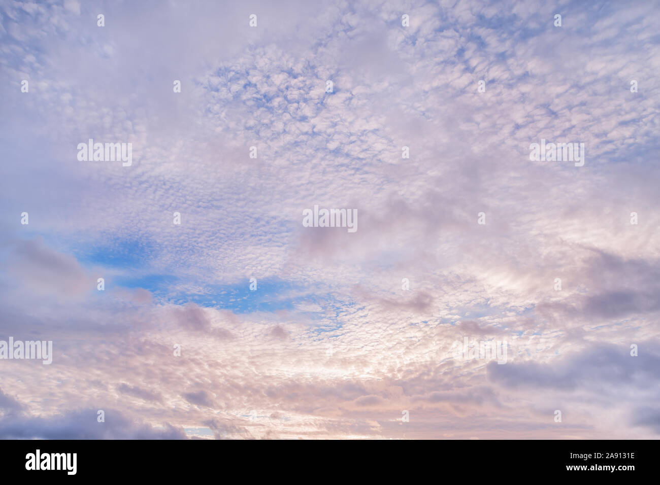 Colored cloudy sky at sunset. Natural texture and background Stock Photo