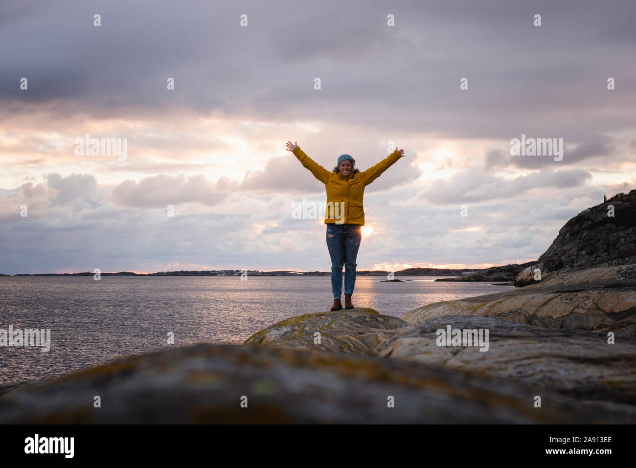 Woman on rocky coast Stock Photo