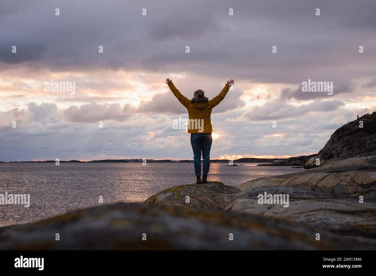 Woman on rocky coast Stock Photo