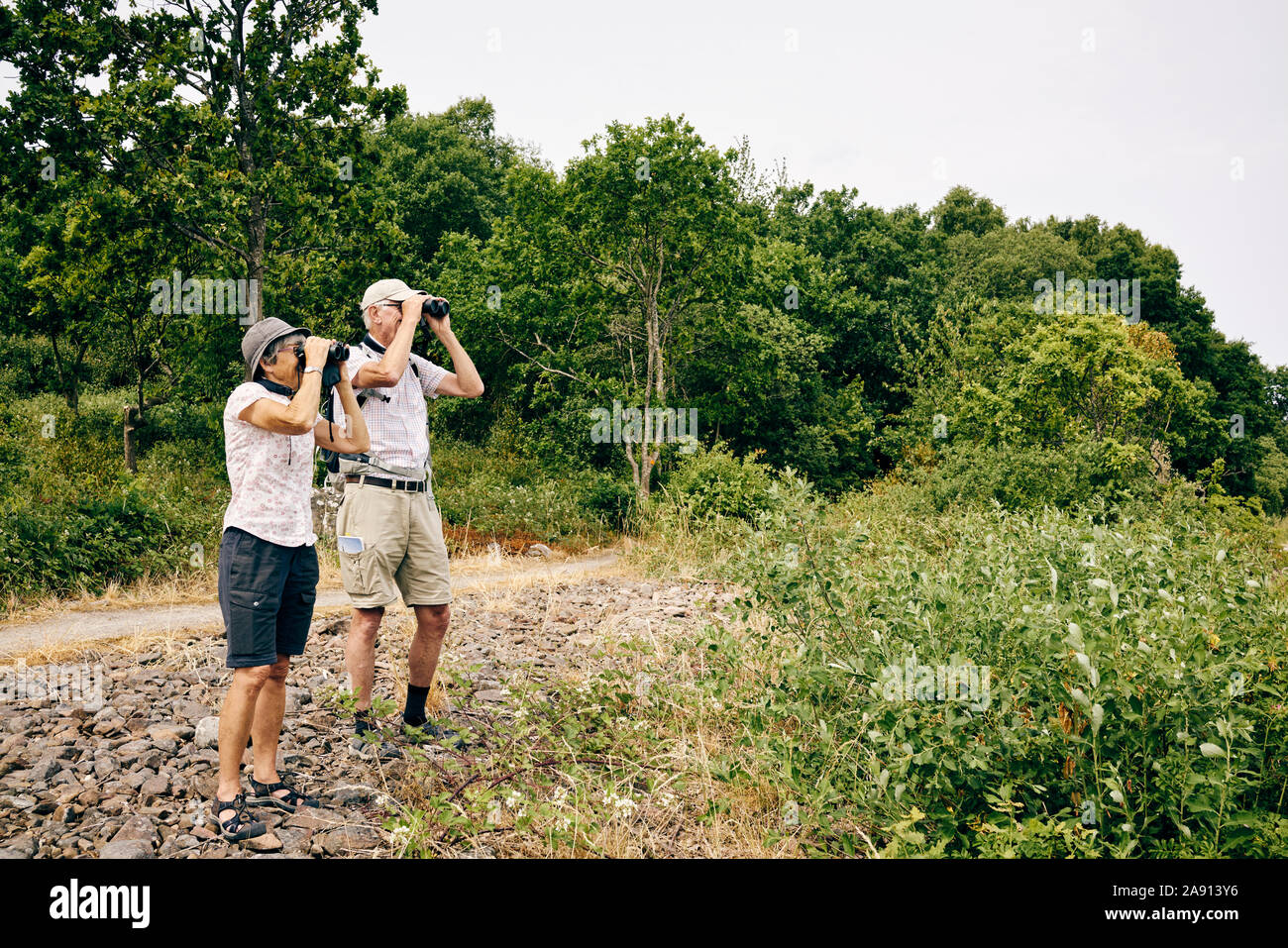 Senior couple looking through binoculars Stock Photo