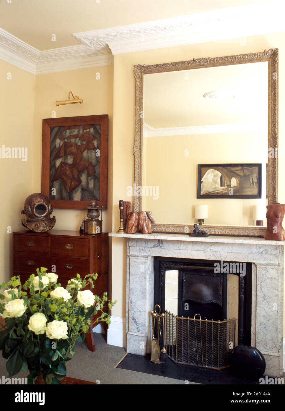 Mirror above fireplace in townhouse living room Stock Photo