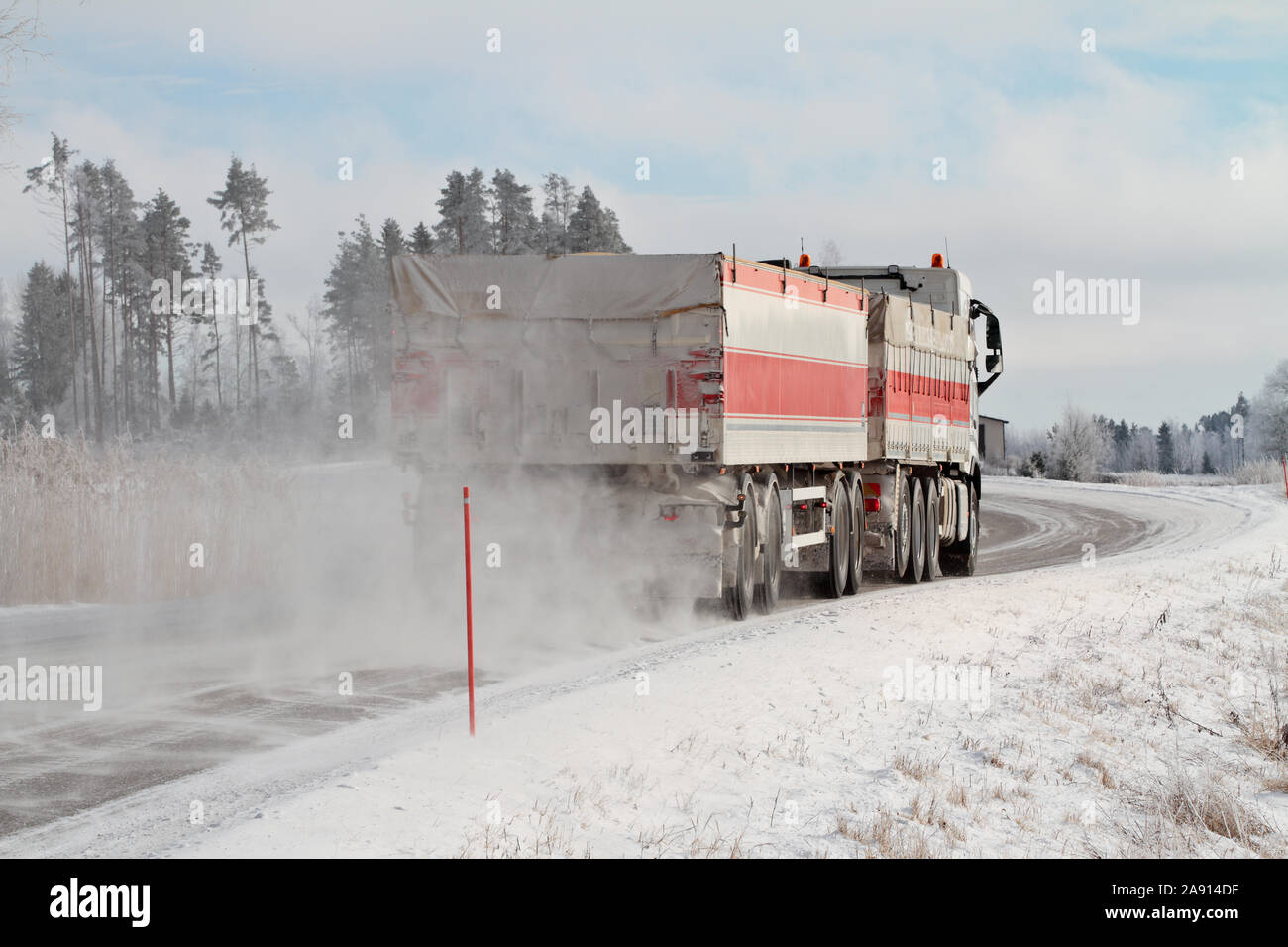 Punkalaidun Finland 02/27/2017 Frost snow blows as the very lomg truck passes by Stock Photo