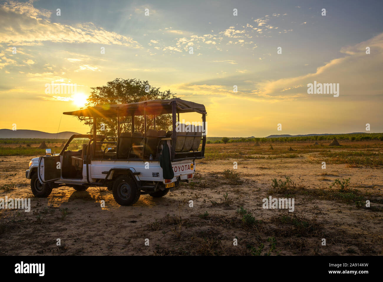 African safari vehicle in the Hobatere game reserve with dramatic sunset Stock Photo