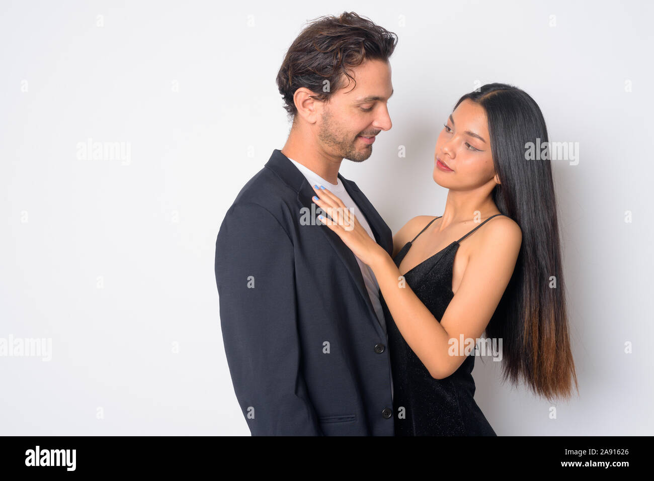 Portrait of multi ethnic business couple facing each other Stock Photo