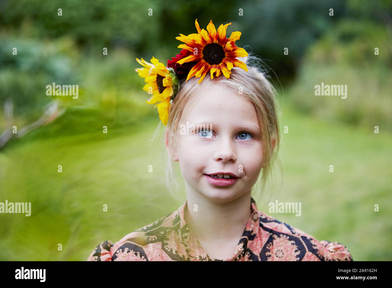 Girl with flowers in hair Stock Photo Alamy
