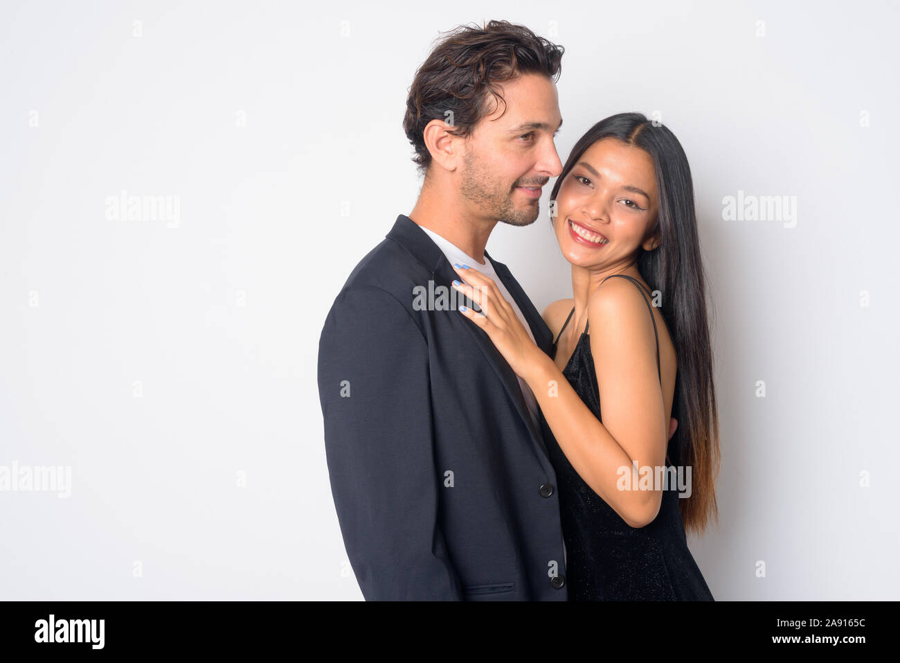 Portrait of happy multi ethnic business couple embracing together Stock Photo
