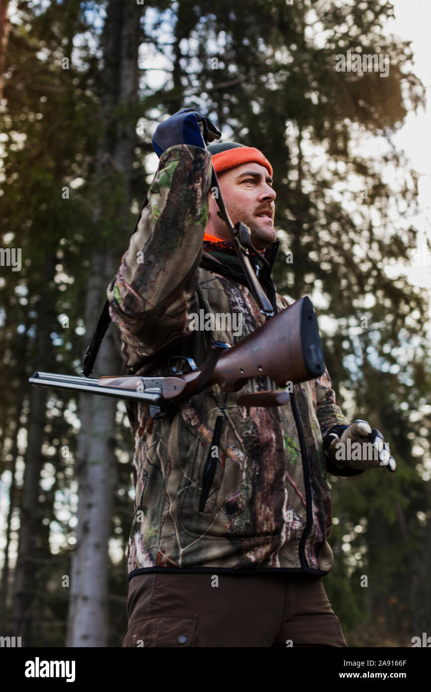 A hunter holding his riffle Stock Photo - Alamy