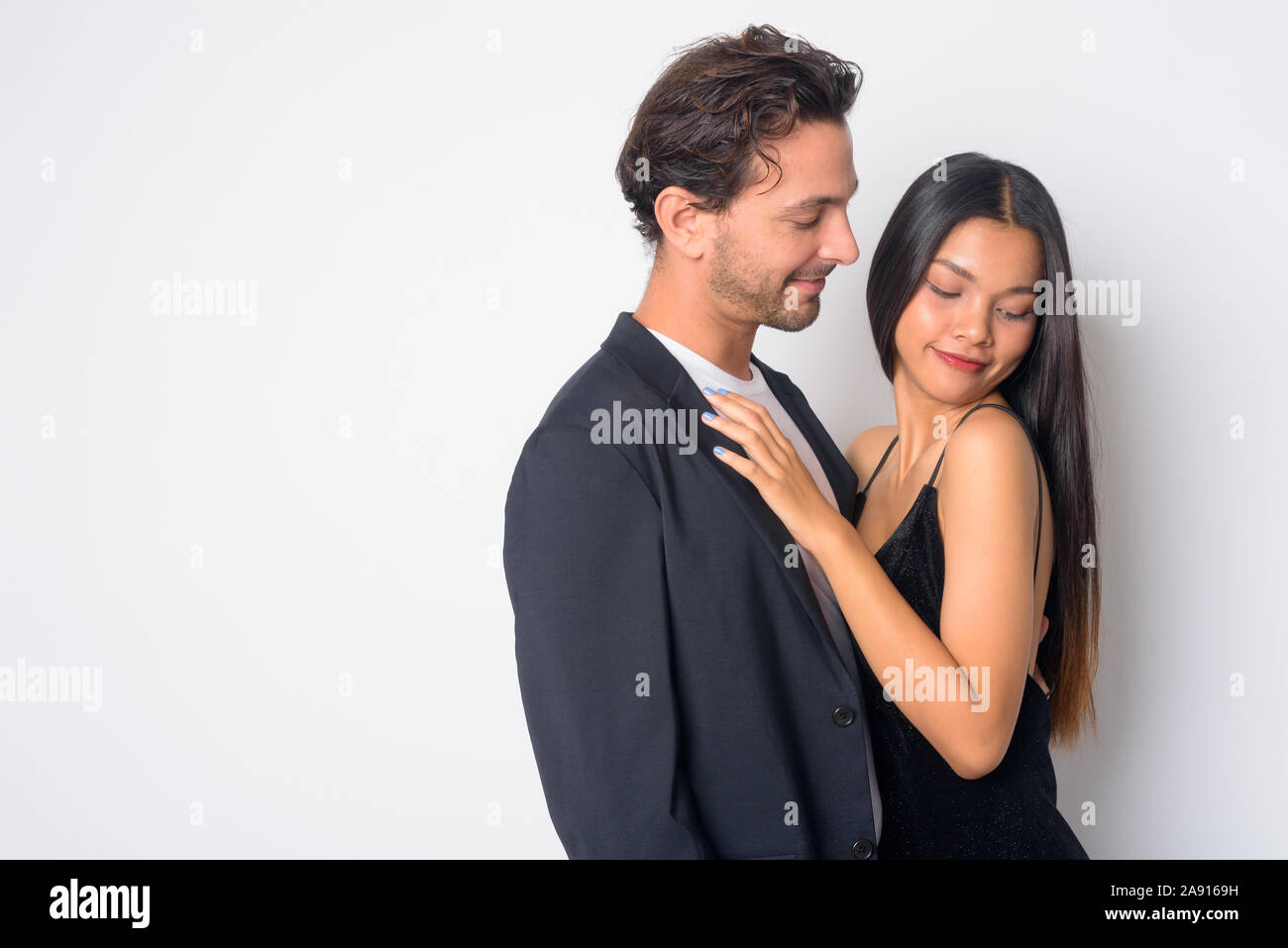 Portrait of multi ethnic business couple hugging each other Stock Photo